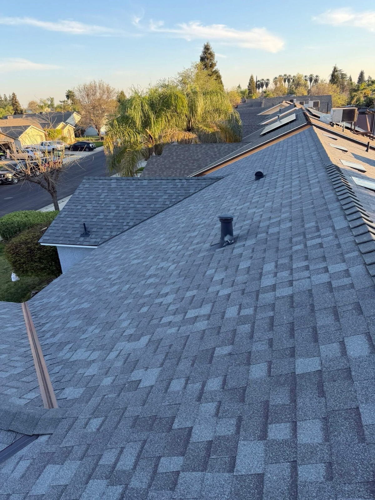 Completed gray architectural-shingle roof by Alonso’s Imperio Roofing